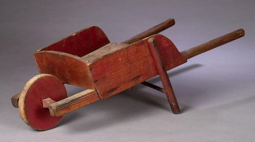 Child's wheelbarrow in original red paint, early 20th century