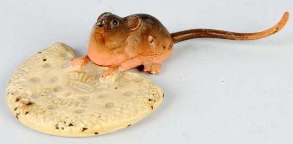 A cast iron mouse and biscuit paperweight, advertising Crown Biscuits