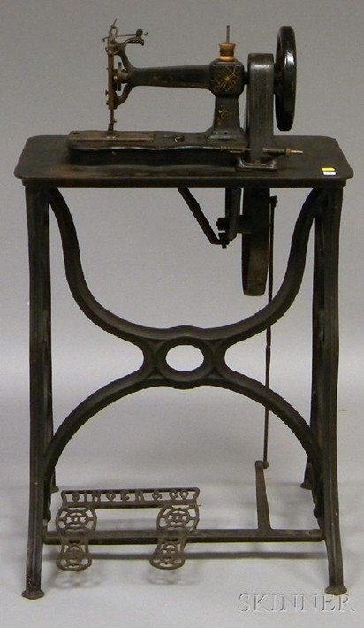 Singer & Co. black-painted and gilt-decorated cast iron treadle-base, belt-driven sewing machine