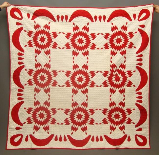 A 19th century American pieced and appliqued quilt, red and white Touching Stars A 19th century American pieced and appliqued quilt, red and white Touching Stars