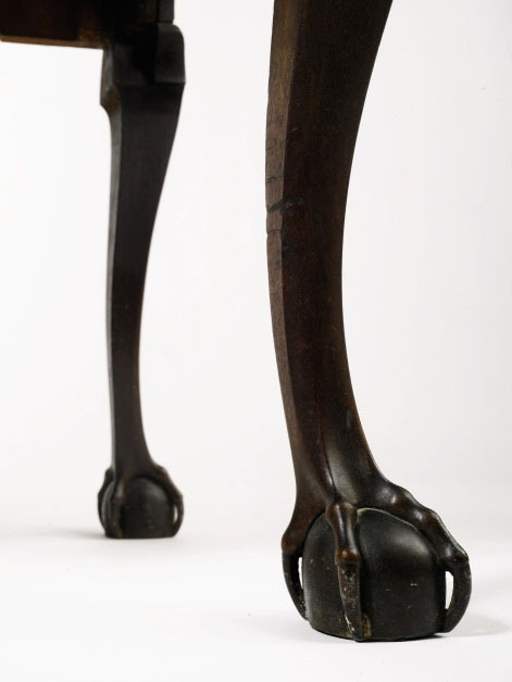 A detailed view of the two proper right cabriole legs on this high chest terminating in carved ball and claw feet with open talons