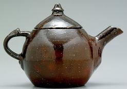 Jugtown teapot having medium to dark brown glaze