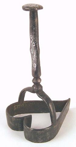 Pennsylvania wrought iron cookie cutter with incised trailing vines on handle