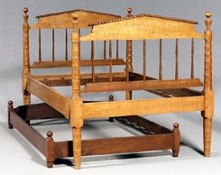 A Tennessee Sheraton tiger maple bedstead, highly figured maple with poplar secondary, head and footboards with pitched pediments and finely turned posts; together with a walnut and cherry trundle bed