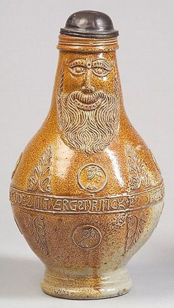 A Frechen stoneware Bartmann krug, Germany, 16th/17th century, bearded mask to neck above foliate trim and portrait medallions, and with central banded verse, hinged pewter lid. 