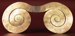 A tumbaga double spiral ornament for ceremonial use, from Tairona; circa A.D. 1000 to 1500.