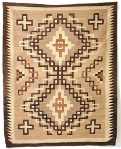 A Navajo Crystal weaving, two shades of brown and cream, with two large diamonds at center, surrounded by four large diamonds and a sawtooth border.