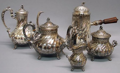 A French Rococo silver tea and coffee service with spiral ribbed pyriform, tab feet; consisting of teapot, coffeepot (6556), creamer (6559), covered sugar bowl, chocolate pot with wood handle side.