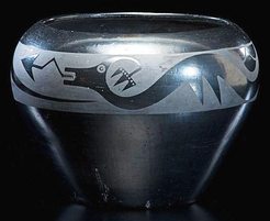Maria Martinez San Ildefonso blackware [pottery] bowl, vasiform with high rounded shoulder gunmetal finish with [decoration of] Avanyu slithering along shoulder; signed Marie on base, circa 1925.