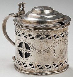 A George III silver crested mustard pot, Charles Aldridge, London, 1786-87. Of pierced drum form, engraved with the crest of a tower and turrets, cobalt blue glass insert, marked beneath. 