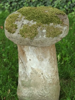 A staddle stone, American, 19th century. Tall, mushroom-shaped stone.